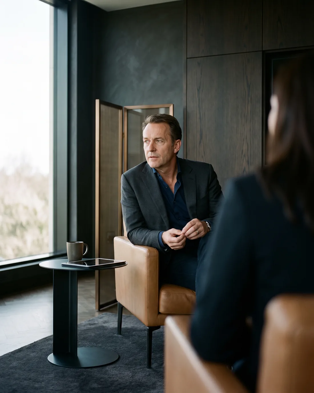 A senior CHRO reviewing the work in a calm Oslo boardroom